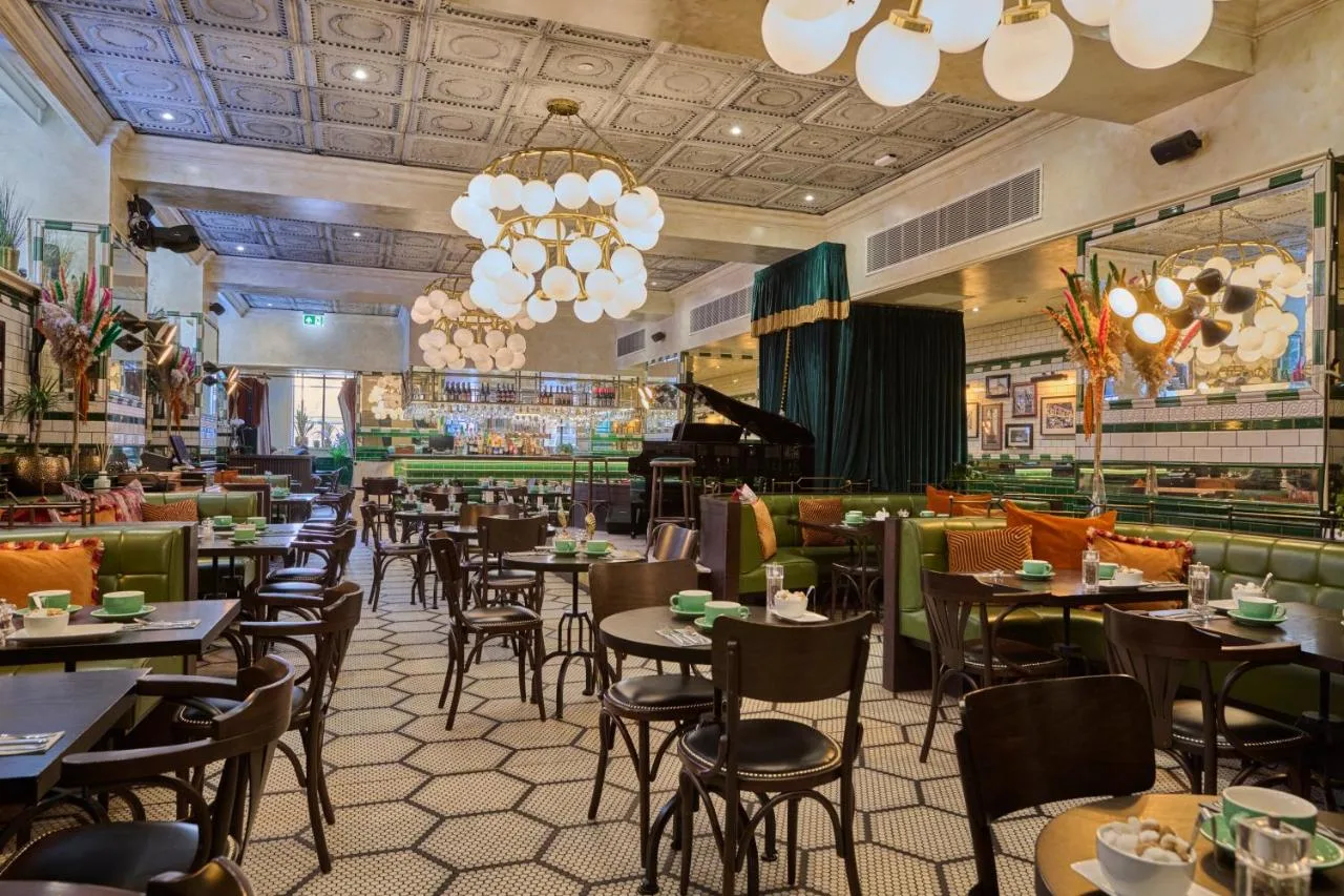 a restaurant with tables and chairs and a bar at The Grand Hotel Birmingham in Birmingham