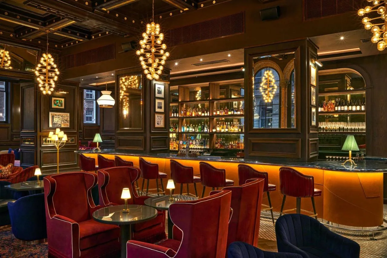 a bar at a restaurant with chairs and tables at The Grand Hotel Birmingham in Birmingham